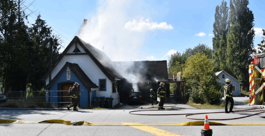 Firefighters fight an inferno tearing through the former Surrey Little Theatre building on 184 Street in Clayton Heights