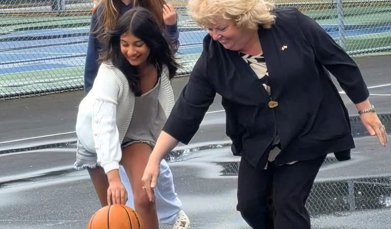 Mayor Brenda Locke playing basketball with Surrey youth during the launch of the city’s free self-service sports equipment program at a local park.