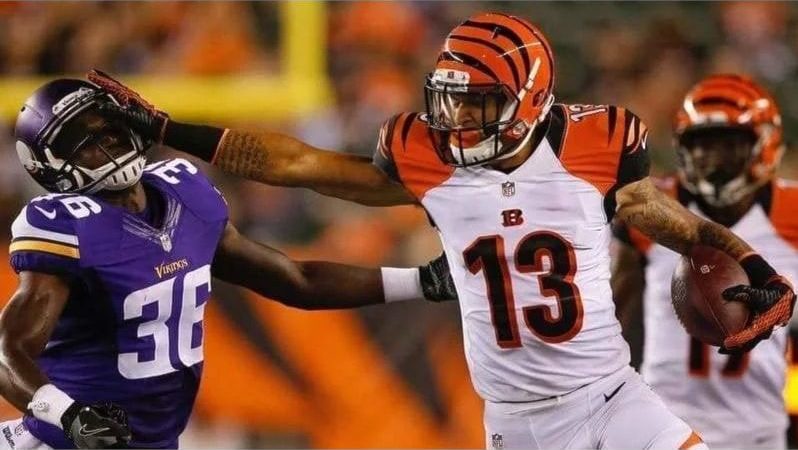 Rashaun Simonise in action during his professional football career before founding Wide Receiver University in Surrey.