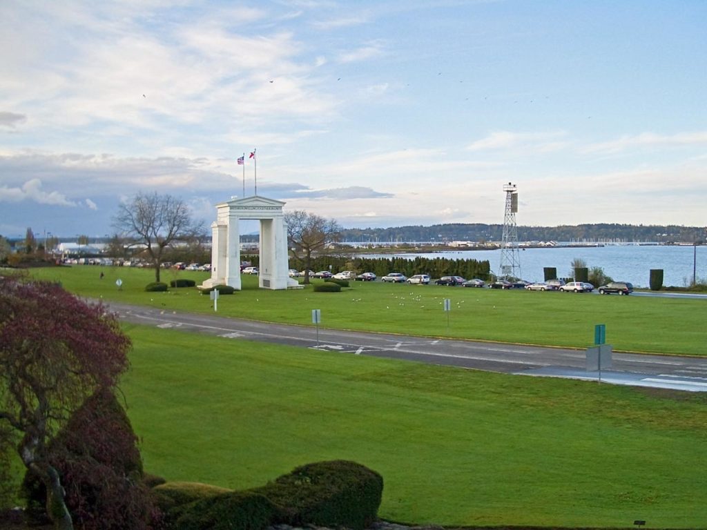 Peace Arch on the U.S.–Canada border with shared lawns and Semiahmoo Bay in the background at Peace Arch Park.