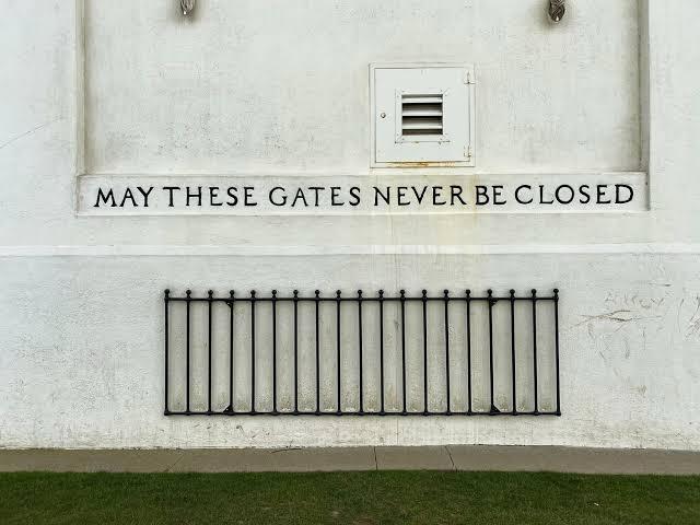 Close-up of the Peace Arch inscription reading “May These Gates Never Be Closed” at Peace Arch Park on the Canada–U.S. border.